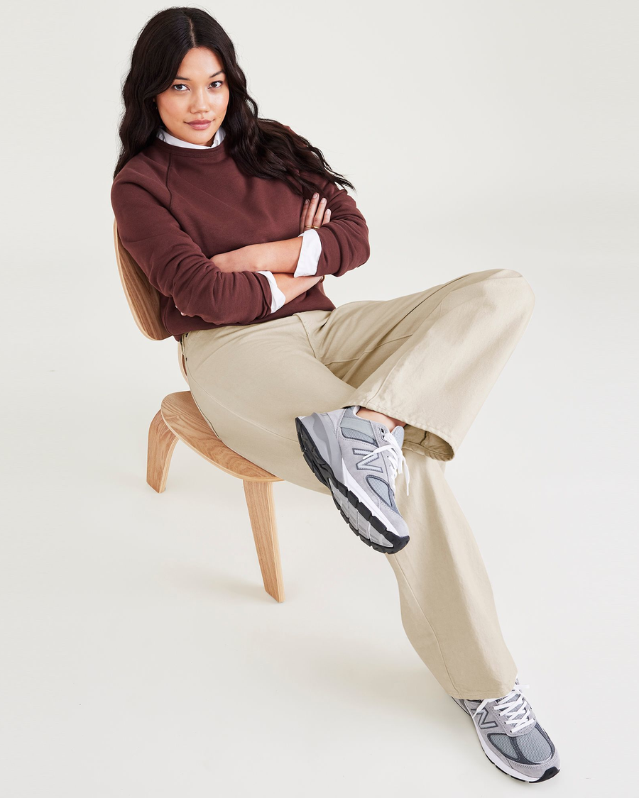 View of model wearing Tan Garment Dye Women's Relaxed Fit Mid-Rise Jeans.