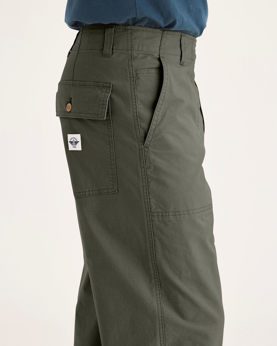 Side view of model wearing Tea Leaf Men's Loose Fit Eighty-Six Utility Pants.