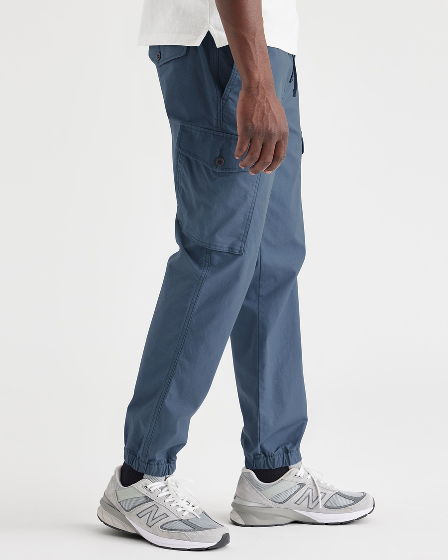 Side view of model wearing Vintage Indigo Men's Straight Tapered Fit Cargo Jogger Pants.